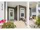Cozy front porch featuring comfortable seating, decorative plants, and a welcoming door with a wreath at 314 Bumble Circle, Murrells Inlet, SC 29576