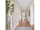 Inviting hallway with hardwood floors, a decorative wreath, and a view into the home's open layout at 314 Bumble Circle, Murrells Inlet, SC 29576
