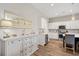 Bright kitchen featuring white cabinets, stainless steel appliances and wood flooring at 314 Bumble Circle, Murrells Inlet, SC 29576