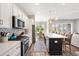 Well-lit kitchen with white cabinets, an island and stainless steel appliances at 314 Bumble Circle, Murrells Inlet, SC 29576