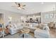 Spacious living area with a sectional sofa, open to a modern kitchen with white cabinetry and counter seating at 314 Bumble Circle, Murrells Inlet, SC 29576