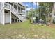 Spacious backyard featuring a deck, stairs, outdoor seating, and lush greenery at 327 A Lakeside Dr., Surfside Beach, SC 29575