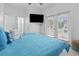A modern bedroom boasts a television, balcony access and a view to the outdoors at 327 A Lakeside Dr., Surfside Beach, SC 29575