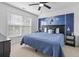 Bedroom with a blue comforter, decorative pillows, and a dolphin art wall at 327 A Lakeside Dr., Surfside Beach, SC 29575