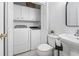 Compact laundry area with modern washer and dryer, ample storage, and convenient toilet and sink at 327 A Lakeside Dr., Surfside Beach, SC 29575