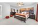 Bright bedroom with a sunset mural behind the bed, complemented by matching decor and a ceiling fan at 327 A Lakeside Dr., Surfside Beach, SC 29575