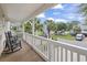 Inviting porch with rocking chairs, offering a relaxing view of the neighborhood's lush, palm-lined street at 327 A Lakeside Dr., Surfside Beach, SC 29575