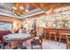 Entertainment space features a custom bar, game table, comfortable seating, and wood ceiling at 328 Waterside Dr., Myrtle Beach, SC 29577