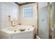 Relaxing bathroom with a soaking tub and a separate glass-enclosed shower at 328 Waterside Dr., Myrtle Beach, SC 29577
