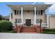 Grand entrance with brick steps, white columns, and decorative wreaths adorning double front doors at 328 Waterside Dr., Myrtle Beach, SC 29577