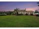 Stately brick home with a sprawling lawn, mature landscaping, and a columned front porch evoking Southern charm at 328 Waterside Dr., Myrtle Beach, SC 29577