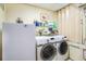 Laundry room equipped with a washer, dryer, and storage shelving at 328 Waterside Dr., Myrtle Beach, SC 29577