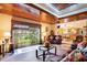 Bright living room featuring wood ceiling, leather sofa, and a large window with a view at 328 Waterside Dr., Myrtle Beach, SC 29577
