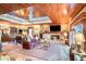 Spacious living room with wood ceiling, brick fireplace, and comfortable leather sofa at 328 Waterside Dr., Myrtle Beach, SC 29577