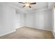 A bright bedroom features neutral walls, carpeted floors, and a ceiling fan at 3547 Ladybank Loop, Myrtle Beach, SC 29577