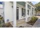 Inviting front porch with white columns, black shutters, and a blue painted ceiling at 3547 Ladybank Loop, Myrtle Beach, SC 29577