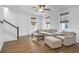 Bright living room featuring hardwood floors, neutral furniture, and lots of natural light at 3547 Ladybank Loop, Myrtle Beach, SC 29577