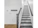 Staircase featuring dark wood handrail, white risers, and black treads at 3547 Ladybank Loop, Myrtle Beach, SC 29577