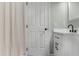 Cozy bathroom features shower with a gray striped curtain and white vanity with black hardware at 3935 Gladiola Ct. # 302, Myrtle Beach, SC 29588