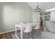 This staged dining area features a white table, chairs, and a modern chandelier at 3935 Gladiola Ct. # 302, Myrtle Beach, SC 29588