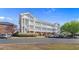 Inviting condo building featuring stairways and a parking lot with landscaping at 3935 Gladiola Ct. # 302, Myrtle Beach, SC 29588