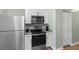 Close-up of modern stainless steel appliances and white cabinets in kitchen at 3935 Gladiola Ct. # 302, Myrtle Beach, SC 29588