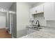 Stylish kitchen featuring granite countertops, stainless steel sink, and white cabinets at 3935 Gladiola Ct. # 302, Myrtle Beach, SC 29588