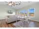 Bright living room features a ceiling fan, dining table, and large windows at 3935 Gladiola Ct. # 302, Myrtle Beach, SC 29588