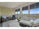 Relaxing screened porch with comfortable seating, views of the lake, and plenty of natural light at 397 St. Julian Ln., Myrtle Beach, SC 29579
