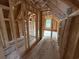 New construction attic showcasing wood beams and a window at 402 S Magnolia Ave., Andrews, SC 29510