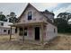 New home construction with Grip Rite house wrap showing gable roof and covered porch at 402 S Magnolia Ave., Andrews, SC 29510