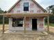 New home construction features a covered front porch and wrapped with Grip Rite house wrap at 402 S Magnolia Ave., Andrews, SC 29510