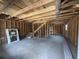 Interior view of framing and plywood walls with space for stairs and window ready for customization at 402 S Magnolia Ave., Andrews, SC 29510