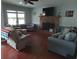 Cozy living room with a brick fireplace, wood floors and comfortable seating at 4083 Sand Trap Ave., Little River, SC 29566