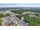 Aerial view showcasing colorful houses in a coastal community surrounded by trees and waterways under a bright sky at 4331 Grande Harbour Blvd., Little River, SC 29566