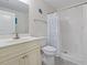 Bright bathroom featuring a shower with blue seashell curtain and a vanity with ample storage at 4331 Grande Harbour Blvd., Little River, SC 29566
