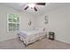 Tranquil bedroom showcasing a cozy bed, mermaid wall art, and natural light from the window at 4331 Grande Harbour Blvd., Little River, SC 29566
