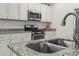 Kitchen sink with stainless steel appliances and granite countertops at 4331 Grande Harbour Blvd., Little River, SC 29566