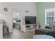 Inviting living room flowing into bedroom, featuring gray sectional, TV and playful decor at 4331 Grande Harbour Blvd., Little River, SC 29566
