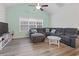 Cozy living room featuring a plush gray sectional sofa, ceiling fan, and neutral decor at 4331 Grande Harbour Blvd., Little River, SC 29566