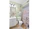 Compact bathroom featuring a vanity sink, toilet, and shower with colorful accents at 4350 Intercoastal Dr. # 1101, Little River, SC 29566