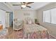 Cozy bedroom decorated with a queen bed, coastal decor, and a view of the window at 4350 Intercoastal Dr. # 1101, Little River, SC 29566