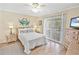 Well-lit bedroom with a comfortable bed, ceiling fan, and access to a private balcony at 4350 Intercoastal Dr. # 1101, Little River, SC 29566