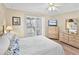 Sunlit bedroom featuring a comfortable bed, dresser, and sliding glass doors to a balcony at 4350 Intercoastal Dr. # 1101, Little River, SC 29566