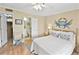Bright bedroom featuring a comfortable bed, closet, and a doorway to an en-suite bathroom at 4350 Intercoastal Dr. # 1101, Little River, SC 29566