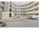 Charming courtyard with stone pathways, decorative landscaping, and multiple balconies at 4350 Intercoastal Dr. # 1101, Little River, SC 29566
