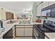 Kitchen with stainless appliances offers views into the dining and living space for open concept living at 4350 Intercoastal Dr. # 1101, Little River, SC 29566