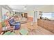 Well-lit living room with cozy seating, hardwood floors, and access to the kitchen and dining areas at 4350 Intercoastal Dr. # 1101, Little River, SC 29566