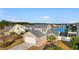 Aerial view of a well-kept home with a two-car garage and backyard water views, surrounded by lush greenery at 4387 Heartwood Ln., Myrtle Beach, SC 29579