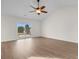 Open-plan living room with hardwood floors, ceiling fan, and a sliding glass door to a patio at 4387 Heartwood Ln., Myrtle Beach, SC 29579